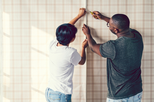 Couple,Decorating,Putting,Up,A,Wallpaper Wallpaper Wonders: Answering Your Top Questions About Installation, Removal, and Maintenance