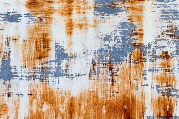 Close-up of a rustic metal texture wallpaper design in shades of orange, white, and blue.